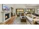 Bright living room features a fireplace and a sliding glass door that overlooks the community's body of water at 3086 S First Water Ln, Gold Canyon, AZ 85118