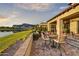 Inviting outdoor patio with lake views and dining area, perfect for relaxing and entertaining in style at 3086 S First Water Ln, Gold Canyon, AZ 85118