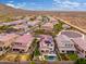This aerial image features a well-planned neighborhood with a glimpse of the desert, showcasing homes with private pools at 31020 N 5Th St, Phoenix, AZ 85085