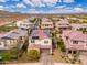A stunning aerial view showcases a beautiful neighborhood with desert views and highlights a home with solar panels on its roof at 31020 N 5Th St, Phoenix, AZ 85085
