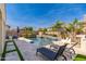 Stunning backyard with a sparkling pool, sun loungers, and a covered bar area for relaxation and entertainment at 31020 N 5Th St, Phoenix, AZ 85085