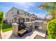 Outdoor kitchen featuring a built-in barbecue area with ample counter space, grill, and storage within a well maintained backyard at 31020 N 5Th St, Phoenix, AZ 85085
