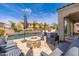 Luxurious backyard featuring a pristine pool, stone fire pit, and comfortable lounge seating at 31020 N 5Th St, Phoenix, AZ 85085
