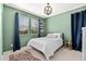 Stylish bedroom with green walls, modern window treatments, and a unique area rug at 31020 N 5Th St, Phoenix, AZ 85085
