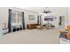 Spacious bonus room with a comfy leather couch, large window, and ceiling fan at 31020 N 5Th St, Phoenix, AZ 85085