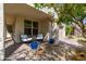 Covered front porch with seating area. Tasteful exterior of the house with potted plants adding charm and curb appeal at 31020 N 5Th St, Phoenix, AZ 85085