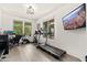 Inviting home office with a treadmill, large windows, and a scenic view displayed on a wall-mounted TV at 31020 N 5Th St, Phoenix, AZ 85085