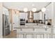 Bright kitchen with white cabinets, modern stainless steel appliances, and a countertop breakfast bar at 31020 N 5Th St, Phoenix, AZ 85085