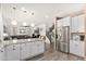 Open floor plan shows kitchen with stainless appliances leading into living room with ceiling fan and staircase at 31020 N 5Th St, Phoenix, AZ 85085