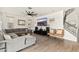 Bright living room features a sectional couch, hardwood floors, ceiling fan, and decorative stairway at 31020 N 5Th St, Phoenix, AZ 85085