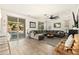 Bright living room boasts a large sectional, wood-look tile floors, and sliding glass doors leading to the outdoor area at 31020 N 5Th St, Phoenix, AZ 85085