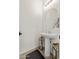 Tastefully decorated powder room with pedestal sink, round mirror, and decorative accents at 31020 N 5Th St, Phoenix, AZ 85085