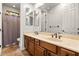 Well-lit bathroom boasting dual sinks, a large mirror, and a separate shower and toilet area at 32020 N 20Th Dr, Phoenix, AZ 85085