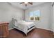 Comfortable bedroom with wood floors, ceiling fan, a full-sized bed, and a dresser at 32020 N 20Th Dr, Phoenix, AZ 85085