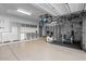 Spacious garage featuring epoxy flooring, ample cabinet storage, and overhead bike rack with exercise equipment at 32020 N 20Th Dr, Phoenix, AZ 85085