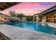 Backyard pool with waterfall features, travertine decking and covered patio at 32020 N 20Th Dr, Phoenix, AZ 85085