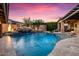 Resort-style backyard pool with waterfall features, travertine decking and lush landscaping at 32020 N 20Th Dr, Phoenix, AZ 85085