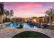 Backyard pool with covered outdoor kitchen, fire features, and beautiful landscaping at 32020 N 20Th Dr, Phoenix, AZ 85085