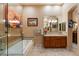 Bright bathroom featuring a bathtub, a glass shower, and tiled vanity at 33269 N 73Rd Pl, Scottsdale, AZ 85266