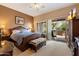 Comfortable bedroom with a king-sized bed, private patio, and a ceiling fan at 33269 N 73Rd Pl, Scottsdale, AZ 85266