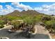 Community entrance with desert landscaping, guarded gate, picturesque mountain backdrop, and stunning blue sky at 33269 N 73Rd Pl, Scottsdale, AZ 85266