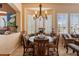 Elegant dining area with decorative lighting, large windows and seating for six at 33269 N 73Rd Pl, Scottsdale, AZ 85266