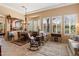 Charming dining room with a round wooden table, area rug, many windows, and seamless access to other living areas at 33269 N 73Rd Pl, Scottsdale, AZ 85266