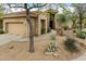 Charming single-story home features a neutral color palette, desert landscaping, and an attached two-car garage at 33269 N 73Rd Pl, Scottsdale, AZ 85266