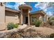 Inviting home showcasing an arched entrance, desert landscaping, and a stone pathway at 33269 N 73Rd Pl, Scottsdale, AZ 85266