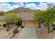 Charming single-story home with a desert-style landscape, tile roof, and two-car garage at 33269 N 73Rd Pl, Scottsdale, AZ 85266