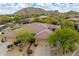 Expansive home features desert landscaping, a private driveway, and neutral colored stucco siding at 33269 N 73Rd Pl, Scottsdale, AZ 85266