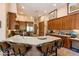 Warm kitchen with a large island with seating and stainless steel appliances at 33269 N 73Rd Pl, Scottsdale, AZ 85266