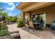 Relaxing outdoor patio with stone flooring, dining table, pond and lush greenery at 33269 N 73Rd Pl, Scottsdale, AZ 85266