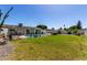 Expansive backyard features lush green grass, desert landscaping, and a sparkling swimming pool at 3516 W Brown St, Phoenix, AZ 85051