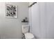 This bathroom features a toilet and a shower with a white shower curtain at 3516 W Brown St, Phoenix, AZ 85051