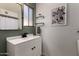 Modern bathroom vanity with white countertop, black faucet, and sleek mirror at 3516 W Brown St, Phoenix, AZ 85051