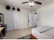 Bright bedroom featuring neutral paint, a ceiling fan, and closet with bi-fold doors at 3516 W Brown St, Phoenix, AZ 85051