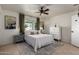 Comfortable bedroom with tile floors, white bedding and gray nightstands at 3516 W Brown St, Phoenix, AZ 85051