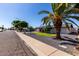 Lovely home featuring a well-manicured lawn, mature trees, and solar panels on the roof for sustainable living at 3516 W Brown St, Phoenix, AZ 85051