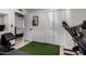 Home gym features a treadmill, workout bench and grass carpet at 3516 W Brown St, Phoenix, AZ 85051