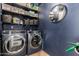 Modern laundry room includes front loading washer and dryer and ample storage space at 3516 W Brown St, Phoenix, AZ 85051