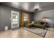 Cozy living room features a green sofa and view of the swimming pool at 3516 W Brown St, Phoenix, AZ 85051