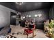 Eclectic living room featuring textured walls, stylish decor, and a cozy red rocking chair on a plush rug at 3516 W Brown St, Phoenix, AZ 85051