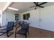 Covered patio with comfortable seating, ceiling fan, and access to the backyard at 3516 W Brown St, Phoenix, AZ 85051