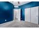 Cozy bedroom features a calming blue accent wall, neutral carpet and large wardrobe at 3597 E Appaloosa Dr, San Tan Valley, AZ 85140