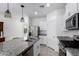 Open kitchen with stainless steel appliances, granite countertops, and a view to the living area at 3597 E Appaloosa Dr, San Tan Valley, AZ 85140