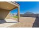 Covered patio overlooks spacious gravel backyard with small grassy area at 3597 E Appaloosa Dr, San Tan Valley, AZ 85140