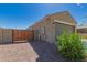 Side yard with gravel, a wooden fence, and access gate to the backyard at 3597 E Appaloosa Dr, San Tan Valley, AZ 85140