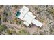 Aerial view of luxury desert home with pool, lush landscaping, and winding driveway at 38199 N Tranquil Way, Carefree, AZ 85377