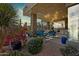 View of an attractive backyard patio with plenty of seating, desert landscaping, and stone accents at 38199 N Tranquil Way, Carefree, AZ 85377